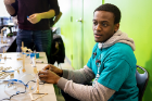 Judge Osazuwa Eghafona, a sophomore chemical engineering major, tests and scores a pulley. This one could pinch/grasp to pick things up, which earned it high marks.
