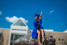 This grad poses for the "cele-BULL-a-tory" photo. Photo: Douglas Levere