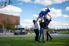 Mohammad Ashour, who received a degree in aerospace engineering, is tossed into the air by his friends near the Bronze Buffalo. Photo: Meredith Forrest Kulwicki
