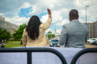 April Baskin (left) waves as graduates begin the parade. At Baskin's right is Rasheed N.C. Wyatt.