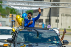 Cameroon Chaney from McKinley High School waves to those who gathered to celebrate the grads.