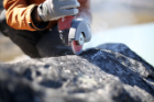 Scientists collect samples from boulders in Greenland. These samples contain chemical isotopes that can help scientists determine the ancient boundaries of the ice sheet. Credit: Jason Briner