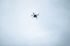 A drone flies over UB’s Geohazards Field Station in Ashford, New York. This UAV has been outfitted with equipment that will enable it to sense and record thermal information as molten rock travels down a sloped surface, cools and solidifies.
