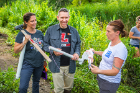 From left: Lancaster High School teachers Amy Balling and Christopher Riley talk with Kimberly Meehan, UB clinical assistant professor of geology, at the edge of Bizer Creek.