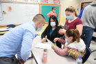 Pharmacy student Anthony Liang with Leilani Ramos, a 10th-grader at East Community High School; Arianiz Ocasio, a fourth-grader at Sedita school, and Angelis Ocasio, a seventh-grader at Sedita.