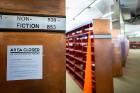 Signs posted on the western stacks explain to library patrons what Caution Sails is all about.