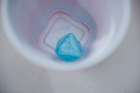 An octahedral electric blue crystal is pictured at the bottom of a Solo cup.
