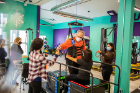 UB occupational therapy students and Motion Project training staff work with client Vince Galletta on the VibePlate parallel bars, which sends whole-body vibrations that are beneficial to clients with spinal cord injuries, stroke, multiple sclerosis and other neurological disorders.