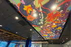 The bold, colorful artwork installed on the ceiling of this seating area was commissioned by UB’s Public Art Committee for One World Café. The piece by Harumo Sato, a 2015 UB graduate, was chosen from a pool of artists.