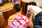 Chaitanya Kuruganty, a master's student studying computer science, helps assemble a conference table at Hope House.