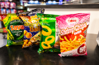 A variety of Calbee snacks: shrimp chips, onion rings, takoyaki balls and Saya green pea crisps.