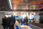 A colorful ceiling mural offers visual interest in the seating area.