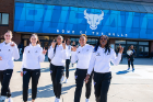 From left: Georgia Woolley, Casey Valenti-Paea, Kaelonn Wilson, Saniaa Wilson and Adebola Adeyeye give a "horns up" as they make their way to the bus.