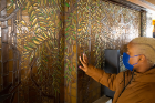 Casidy Campbell examines the wisteria mosaic over the main fireplace. Photo: Douglas Levere
