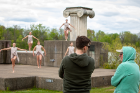 Michael Deeb Weaver (left), clinical assistant professor, and Tom Ralabate confer as they watch the dancers perform.
