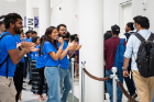 Student volunteers helping with orientation applaud and welcome international students as they make their way into the Center for the Arts for the welcome ceremony.