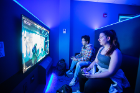 Students play Mortal Kombat 11 in the LevelUp space.