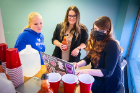 Lindsay Hahn (center) and assistants Madeline Taggart (left) and Irina Andreeva (right) prepare the hot sauce drinks.