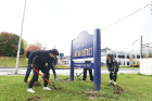 Phil Chen (left) and Daisy Chu, both juniors majoring in business administration, break ground to plant the daffodil bulbs.