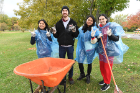Taking a break from cleaning up the South Park golf course are (from left) Annu Priya, a first-year graduate student studying data science; Del Hart, a junior aerospace engineering student; Ankita Shome, a junior studying economics; and Malika Sultonova, a senior biomedical sciences major. "We're helping the groundskeepers," Malika says.