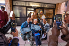 The Evans family poses for photos in front of the doorway bearing his name.