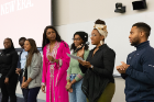 SNMA officers address the group, with Vice President Sydney Johnson at the mic and President Ifeoma Ezeilo (in pink). Also pictured (from left) are Michelle Amankwah, fundraising chair; Kwaku Bonsu, MAPS liaison; Malaika de Weever, secretary; Katherine Foote, treasurer; and Sydney Pigott, social media chair.