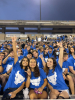 New students throwing their UB horns up in the stands at UB stadium. 
