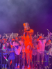 An excited student dumps an entire bucket of glow paint on her head. 