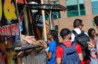 A student gets their tasty wings and fries from a food truck at the Intercultural and Diversity Center Welcome Back BBQ. 
