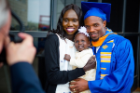 An ALANA graduate celebrates his achievements with his family.