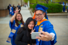 Students pose for a selfie after the annual ALANA celebration, a pre-commencement ceremony to honor the achievements of African, Latino/a, Asian and Native American students and individuals who understand, advocate and appreciate the guiding principles applied by and for people of color in historic, political, educational, economic and social contexts. 