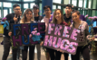 Members of Sigma Psi Zeta and Lambda Phi Epsilon providing “free hugs” in support of mental health awareness and the UB Men’s Group. 