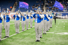 UB Marching band members performing on the field at the MAC Football Championship Game.