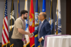 President Triapthi congratulates a graduating veteran student at the annual cord celebration.