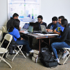 A group of students work on a solution during the Blockchain Buildathon.