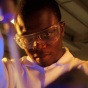 Graduate student with a test tube in the lab. 