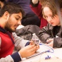 CSE student demonstrates technology to a young visitor. 