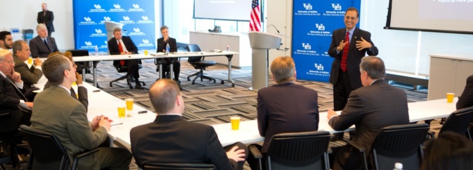 Photo of Satish Tripathi speaking in a meeting room. 