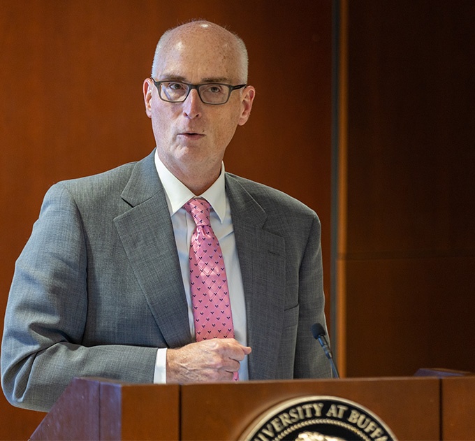 Graham Hammill, dean of the Graduate School, at podium in the Buffalo Room at the University at Buffalo North Campus. 
