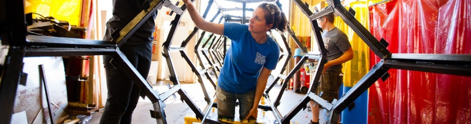 Students paints a star shaped structure. 