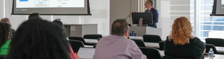 Roberto Pili, MD, speaks at podium. 