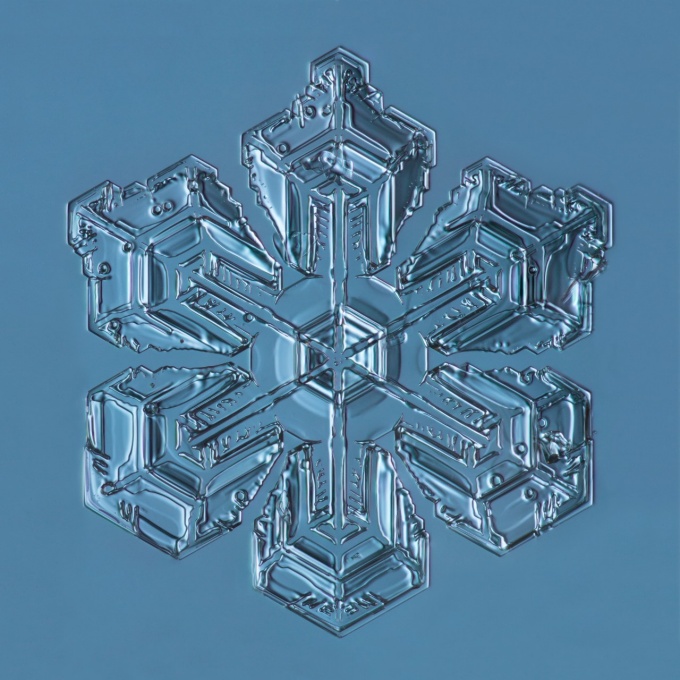 A single snowflake on a blue background. 