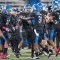 UB football players celebrate on the field. 