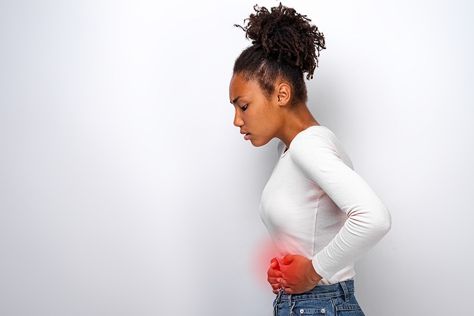 A young woman experiencing stomach pain. 