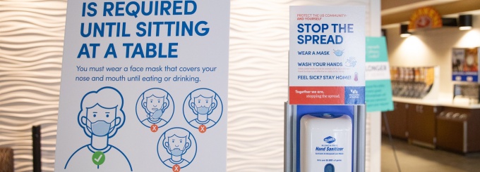 Photo of COVID-19 sign at a UB dining facility. The sign says "A Face Mask is Required Until Sitting at a Table.". 