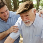 Adult son caring for his elderly father. 