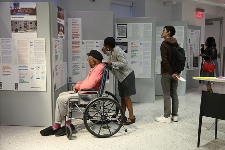 Community members examine the "Now What?!" displays. 