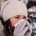 Sick woman outdoors in a winter setting. 