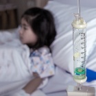 A child in a hospital setting receiving an intravenous treatment. 