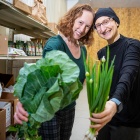 Lucia Leone and Jill Tirabassi hold produce. 